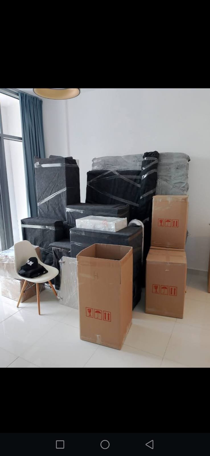 Villa moving company Abu Dhabi — professional crew wrapping furniture